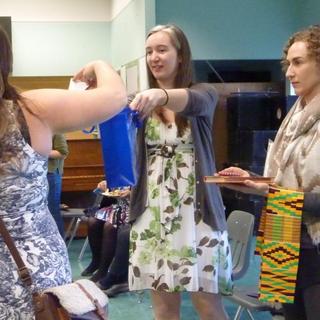 Raffle draw held at the Anthropology Forum 2018; Jessica holding bag with names and Victoria with prizes.